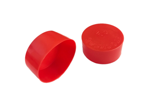 Side-by-side view of two round, red, LDPE injection moulded protective caps—one face down to show the STOCKCAP logo embossed on the closed end, and one on its side.