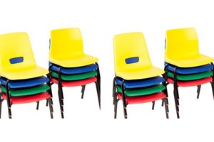 Mulitple colours of stacked primary school chairs.