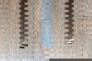 Top-down view of a square black injection-moulded foot insert fitted to the end of a metal tube leg, with an angled base profile visible.