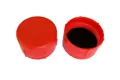 Angled side-by-side view of two red, LDPE BSP threaded caps—one facing up and one facing down showing a rubber gasket inside.