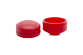 Angled front-top view of the cover sections of two red LDPE injection moulded secure nut and bolt cover caps.