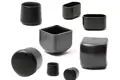 Side view of eight varying black plastic injection moulded chair feet. Some are round, some square and some oval in shape.