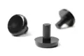 Small black plastic pegs used as buffers between stacking chairs.