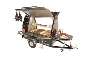 Mobile BBQ trailer in use with visible red PVC handle grip on the front tow bar.