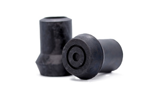 Side view of two black rubber injection moulded "Style D" feet with a flanged base used for walking sticks.