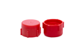 Side-by-side view of two red, LDPE BSP threaded caps—one facing up and one facing down.