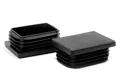 Angled view of two black rectangular plastic feet inserts for table legs.