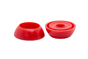 Angled front-top view of the base sections of two red LDPE injection moulded secure nut and bolt cover caps.