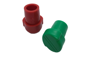 Red and green versions of angled internal fitting chair ferrules for school chairs.