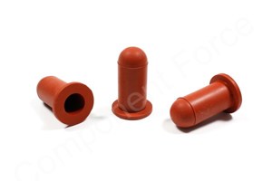 Side-by-side view of three round, rusty red, hi-temp silicone injection moulded washer caps—one upright and two on their sides facing in different directions.