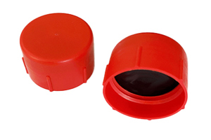 Side-by-side view of two red, plastic metric threaded caps—one upright and one tilted to display the open end showing a rubber sealing disc.