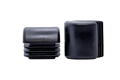 Two square, domed plastic insert feet for school chairs and tables in black.
