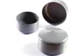 Angled view of three round, grey, flexible PVC dip moulded pole caps—one upright, one inverted, and one positioned on its side.
