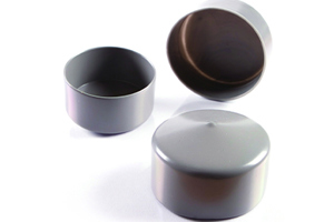 Angled view of three round, grey, flexible PVC dip moulded pole caps—one upright, one inverted, and one positioned on its side.