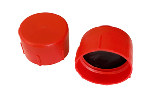 Side-by-side view of two red, LDPE metric threaded caps—one upright and one tilted to display the open end showing a rubber gasket seal.