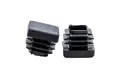 Two square plastic tube inserts used as chair feet for school furniture in black.