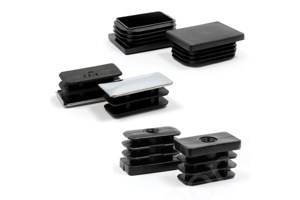 Angled view of six plastic rectangular tube inserts: two with a textured surface, two with a chrome finish, and two with a female thread to accommodate adjustable feet.