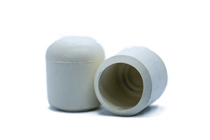 Side view of two white straight-sided rubber injection moulded chair feet. One facing up, one facing sideways to see the open end.