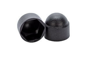Side-by-side view of two domed, black, plastic nut caps—one upright and one tilted to display the hexagonal open end.