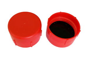 Angled side-by-side view of two red, LDPE British Standard Pipe threaded caps—one facing up and one facing down showing a rubber gasket inside.