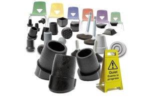 Collection of plastic feet for school chairs with a backdrop of school chairs and signs.