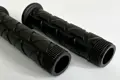 Top down angeld view of two injection moulded grips. They are both black with a triangular pattern.