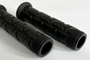 Top down angeld view of two injection moulded grips. They are both black with a triangular pattern.