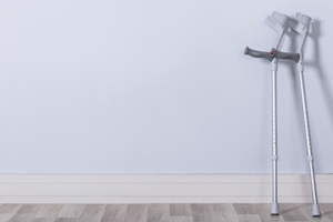 A pair of walking crutches with injection moulded, grey, rubber feet as the base.