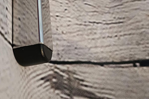 Top-down view of a square black injection-moulded foot insert fitted to the end of a metal tube leg, with an domed base profile visible.