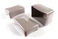 Angled view of three rectangular, grey, flexible PVC dip moulded protective caps—two shown upright and one inverted to display the open interior.