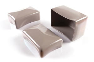 Angled view of three rectangular, grey, flexible PVC dip moulded protective caps—two shown upright and one inverted to display the open interior.